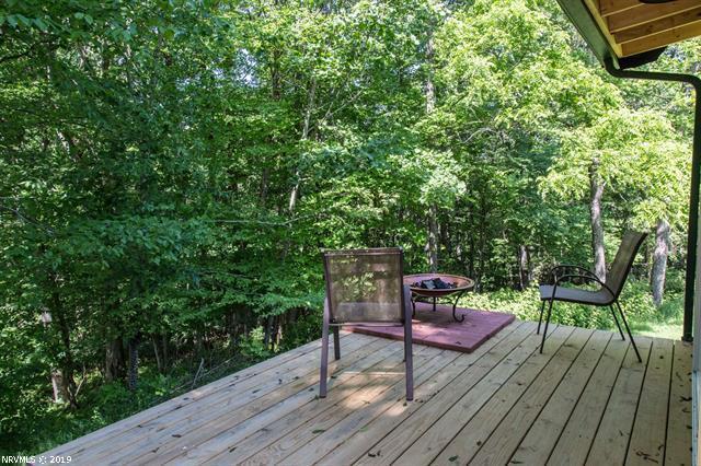 2094 Union School Road Southwest Willis, VA 24380 - Photo 27 of 40 a wooden bench sitting in the middle of a forest