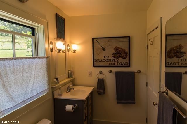 2094 Union School Road Southwest Willis, VA 24380 - Photo 7 of 40 a bathroom with a sink mirror and a shower