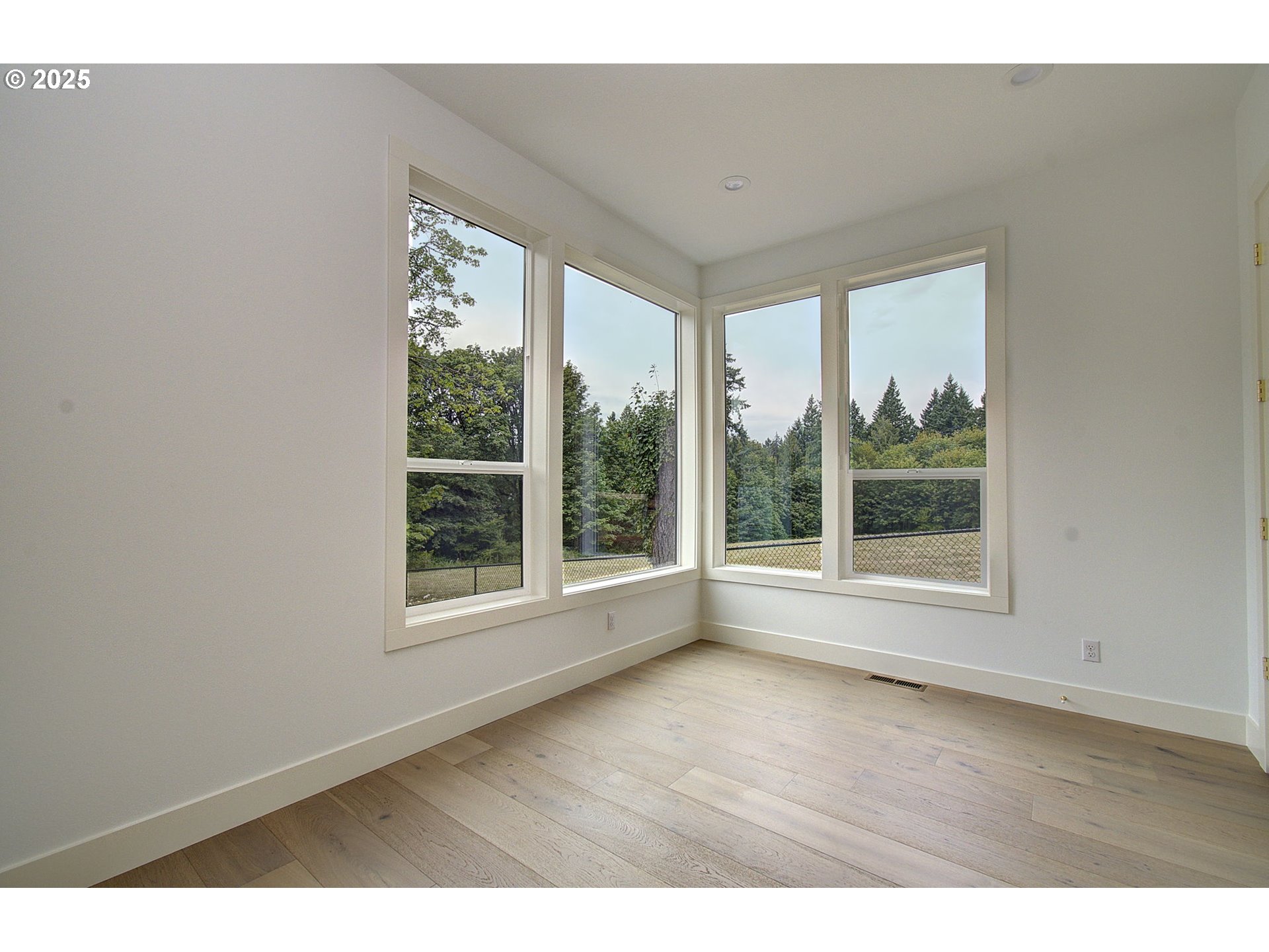 2012 Northeast 159th Street Ridgefield, WA 98642 - Photo 13 of 47 a view of an empty room with wooden floor and a window