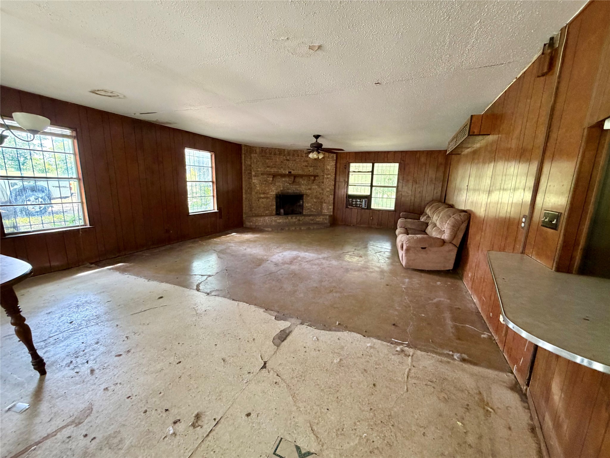 2501 Barnhardt Road Temple, TX 76502 - Photo 6 of 25 A corner fireplace anchors this spacious living area, offering a cozy retreat with ample natural light.