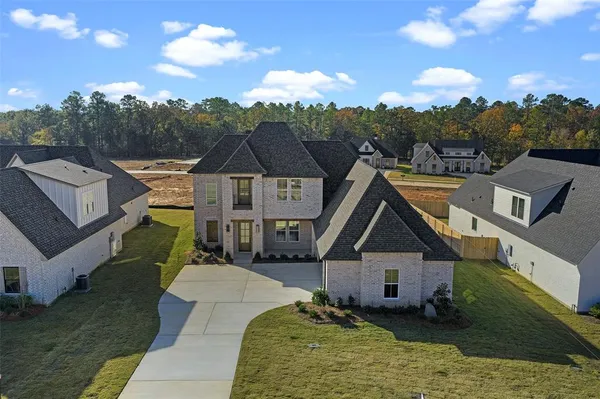 a aerial view of a house next to a big yard