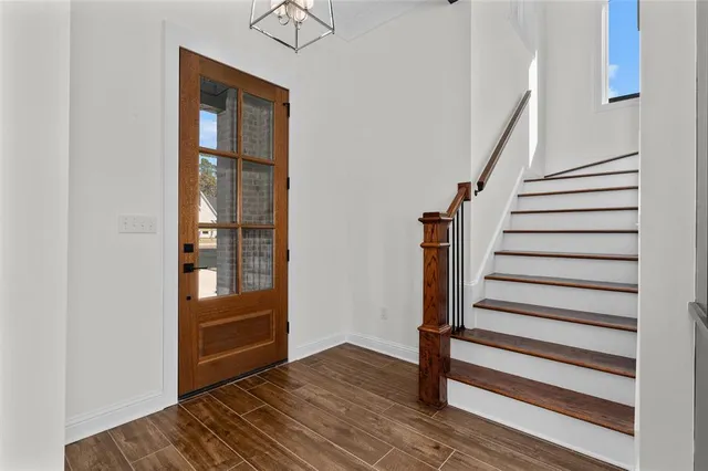 a view of entryway and hall with wooden floor