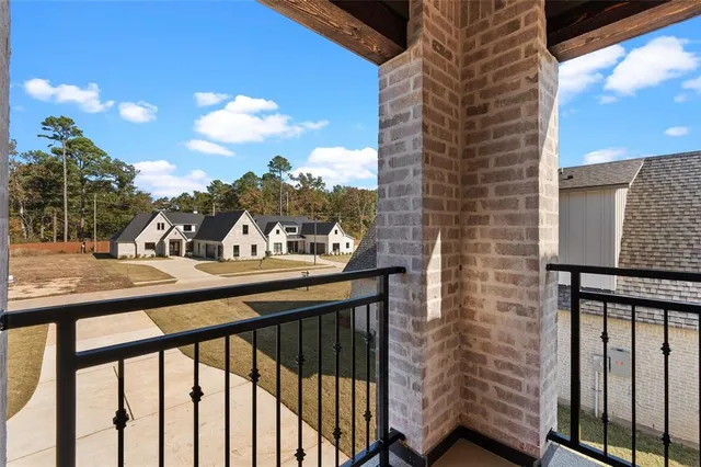 a bathroom with a granite countertop toilet sink and mirror