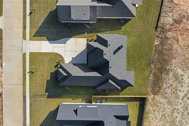an aerial view of residential houses with outdoor space
