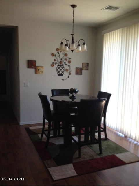 1250 South Rialto, Unit 62 Mesa, AZ 85209 - Photo 7 of 24 a view of a dining room with furniture window and wooden floor