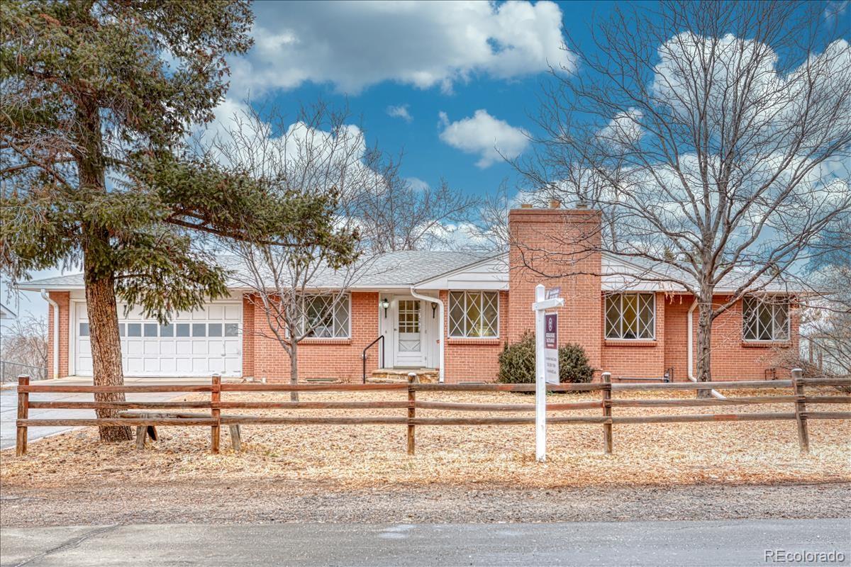 a front view of a house with a tree