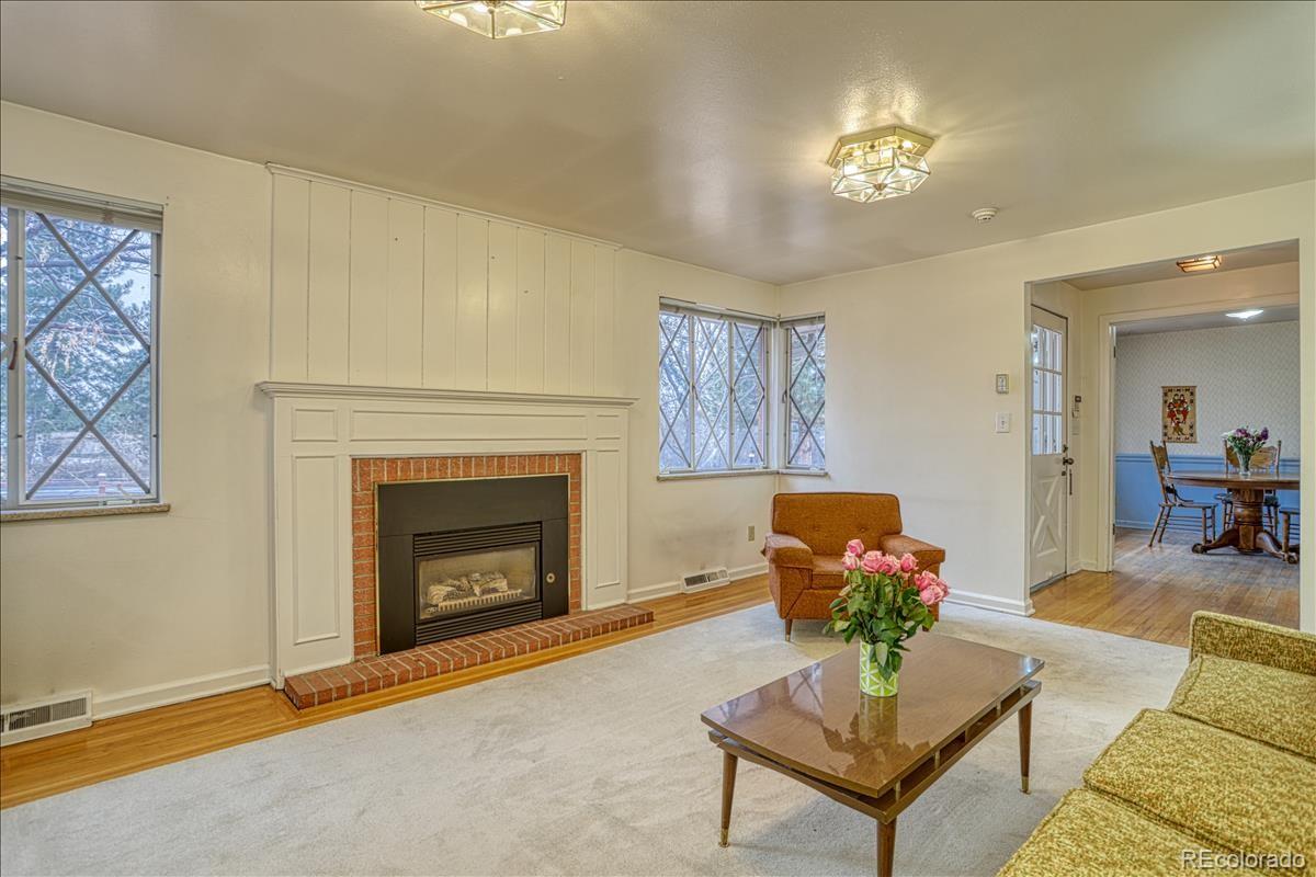 1279 West Ridge Road Littleton, CO 80120 - Photo 4 of 16 a living room with furniture and a fireplace