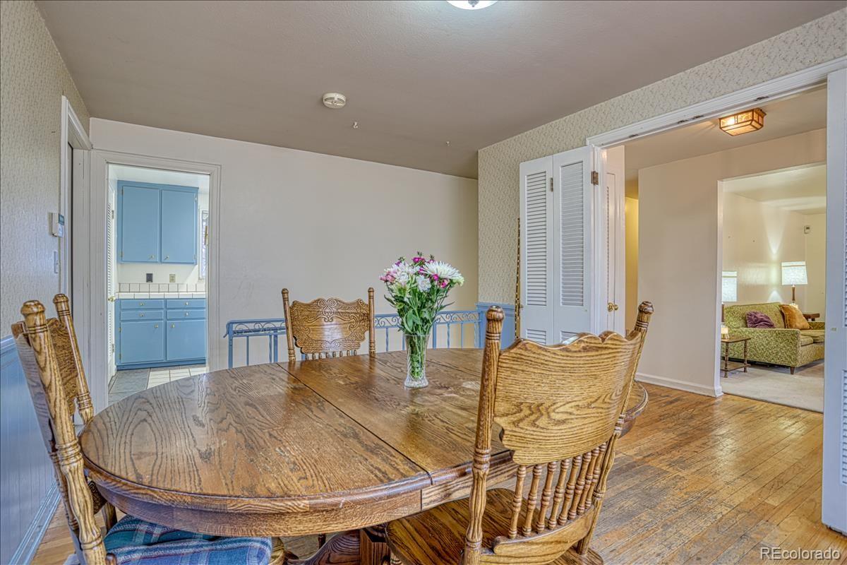1279 West Ridge Road Littleton, CO 80120 - Photo 5 of 16 a dining room with furniture and wooden floor