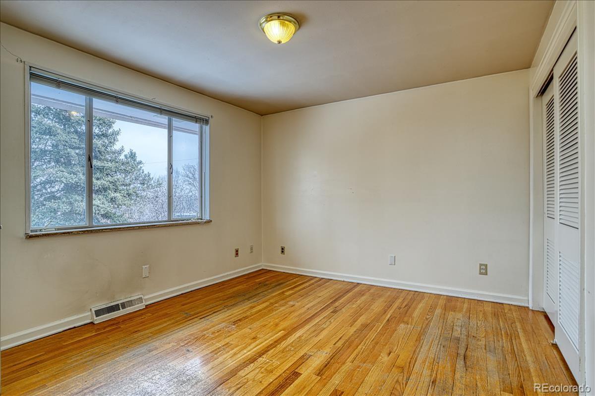 1279 West Ridge Road Littleton, CO 80120 - Photo 8 of 16 a view of empty room with wooden floor and fan