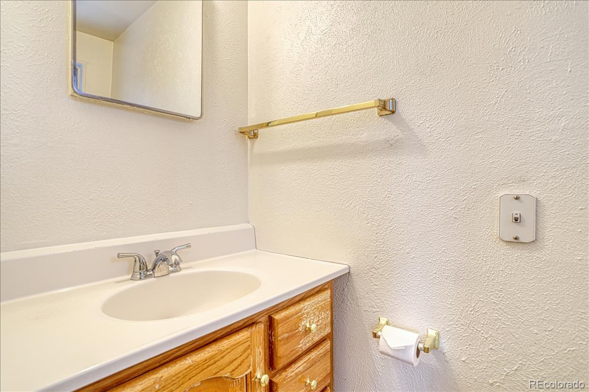 1279 West Ridge Road Littleton, CO 80120 - Photo 9 of 16 a bathroom with a sink and a mirror