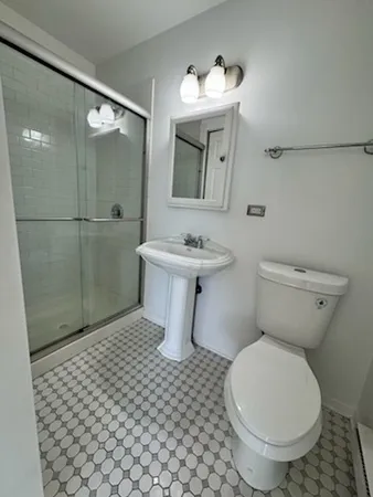 a bathroom with a sink toilet and shower