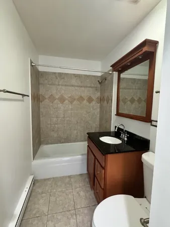 a bathroom with a toilet a sink and bathtub