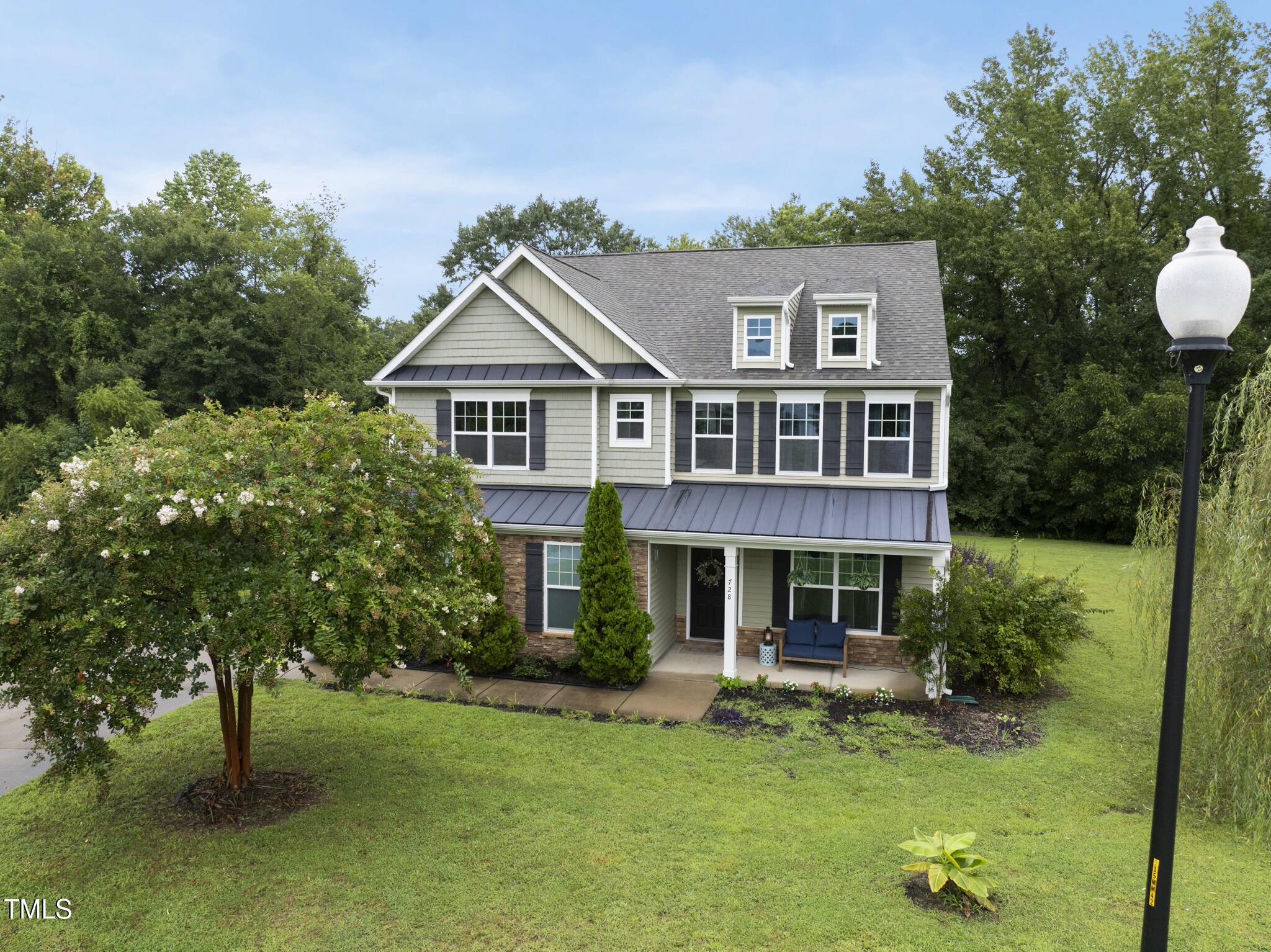 728 Spruce Meadows Lane Willow Spring, NC 27592 - Photo 1 of 45 a front view of a house with a garden