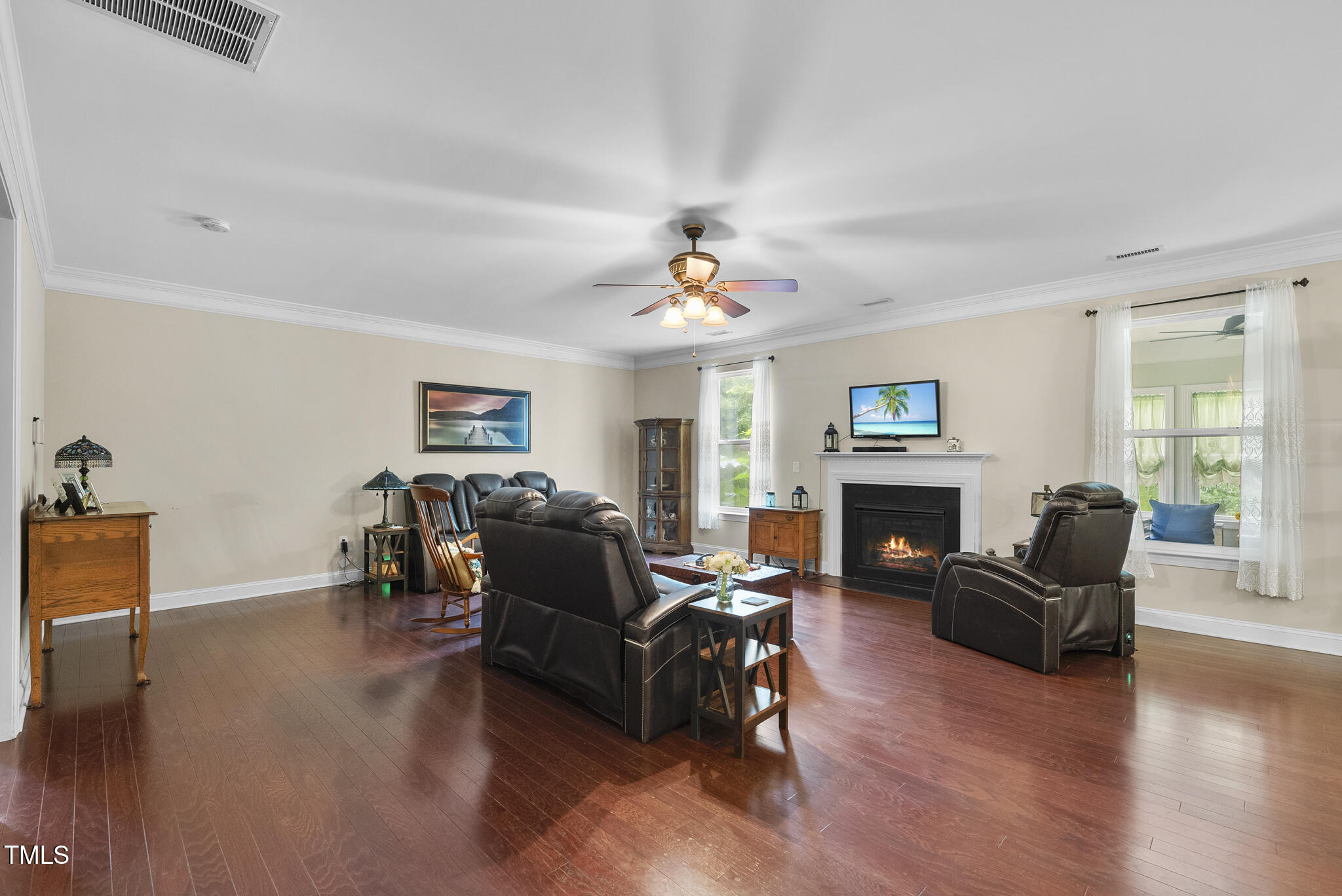 728 Spruce Meadows Lane Willow Spring, NC 27592 - Photo 11 of 45 a living room with furniture a fireplace and a flat screen tv
