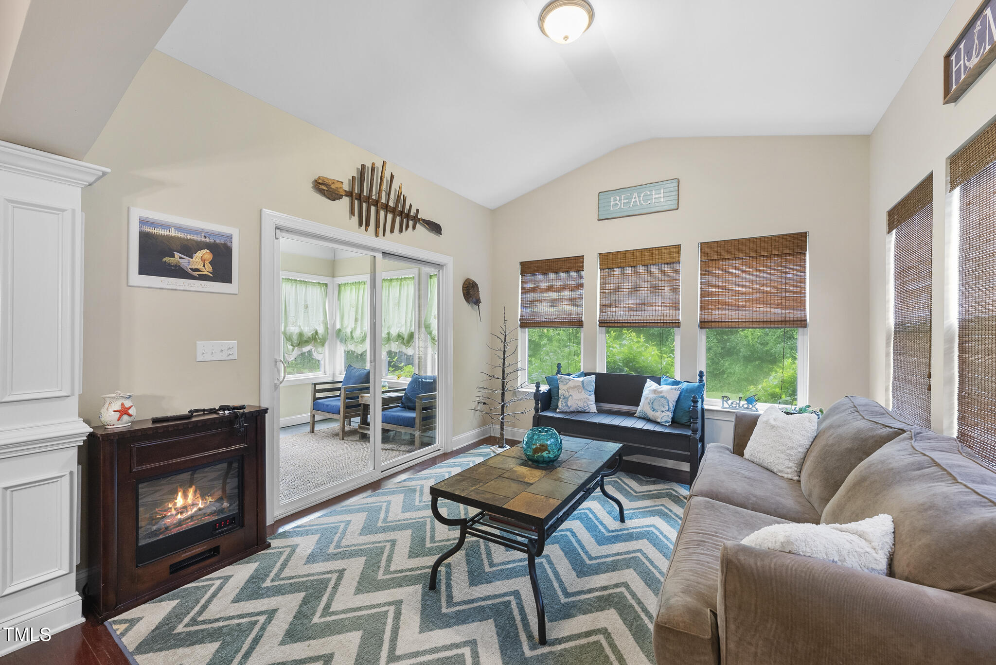 728 Spruce Meadows Lane Willow Spring, NC 27592 - Photo 15 of 45 a living room with furniture a flat screen tv and a fireplace
