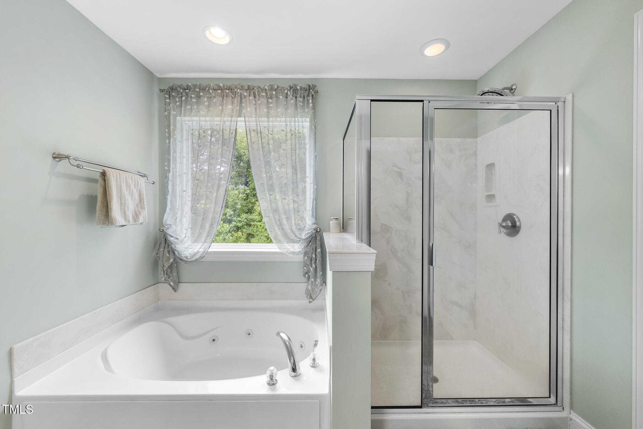 728 Spruce Meadows Lane Willow Spring, NC 27592 - Photo 23 of 45 a bathroom with a bathtub a shower and a window