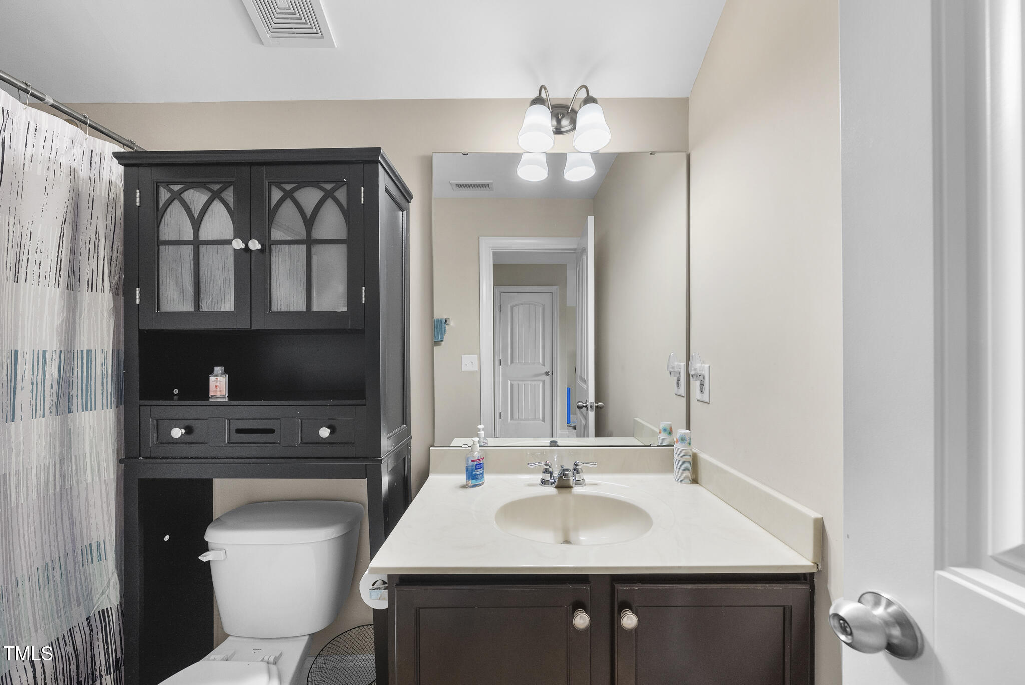 728 Spruce Meadows Lane Willow Spring, NC 27592 - Photo 32 of 45 a bathroom with a sink a toilet and a mirror