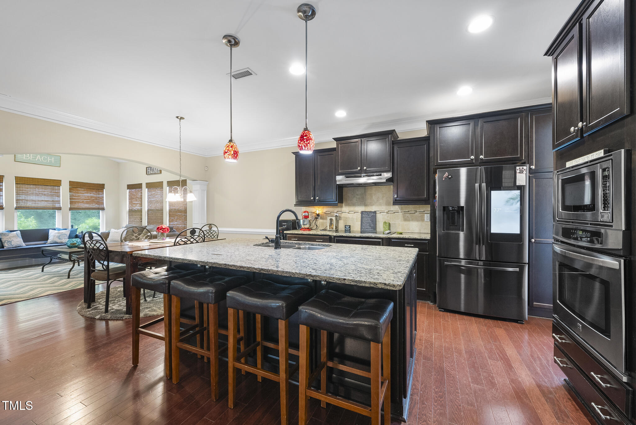 728 Spruce Meadows Lane Willow Spring, NC 27592 - Photo 8 of 45 a kitchen with stainless steel appliances granite countertop a table chairs stove and refrigerator