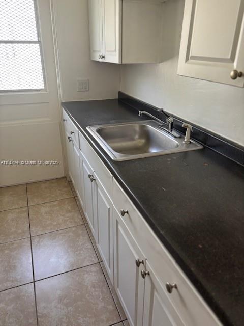 1085 94th Street, Unit 9407 Bay Harbor Islands, FL 33154 - Photo 5 of 6 a kitchen with a sink a counter top space and cabinets