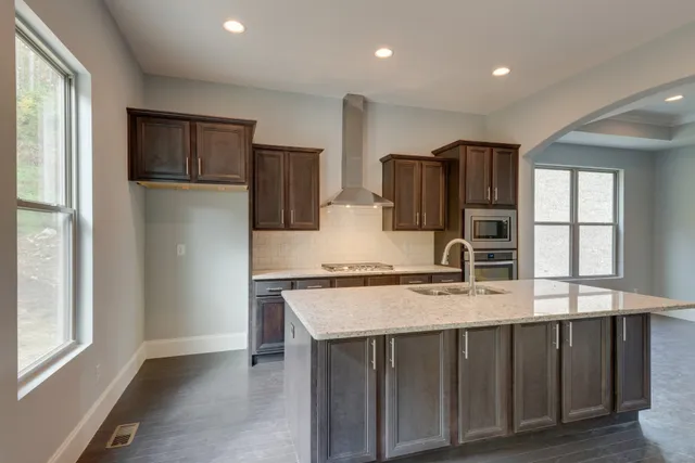 a bathroom with a granite countertop sink a large mirror and vanity