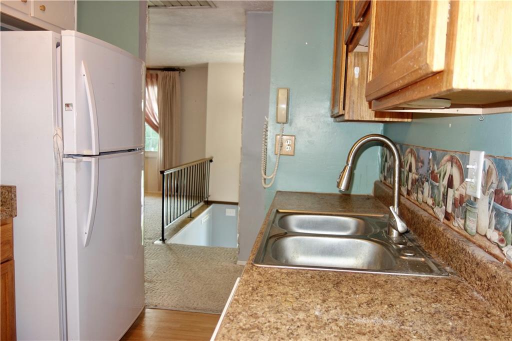 120 Wren Way Washington, PA 15301 - Photo 12 of 30 a kitchen with a refrigerator a sink and a stove top oven