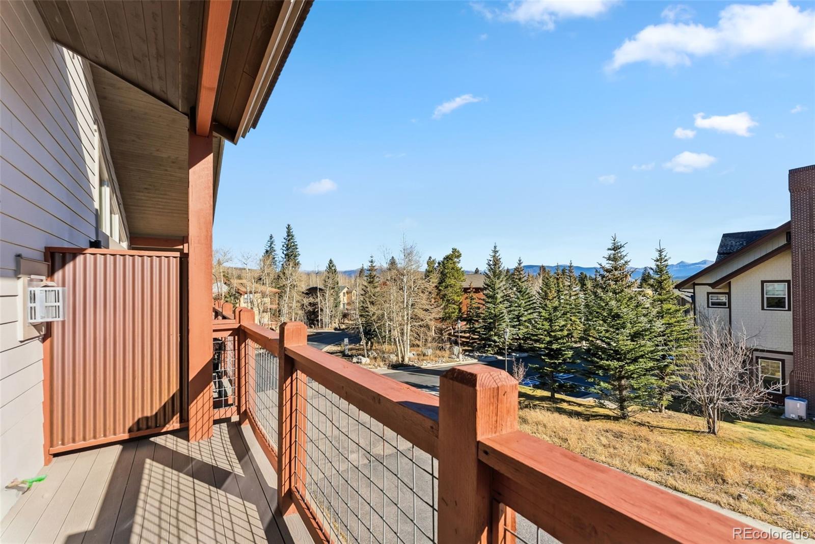 481 West Main Street, Unit B201 Frisco, CO 80443 - Photo 2 of 26 a view of a balcony with wooden chairs and iron fence