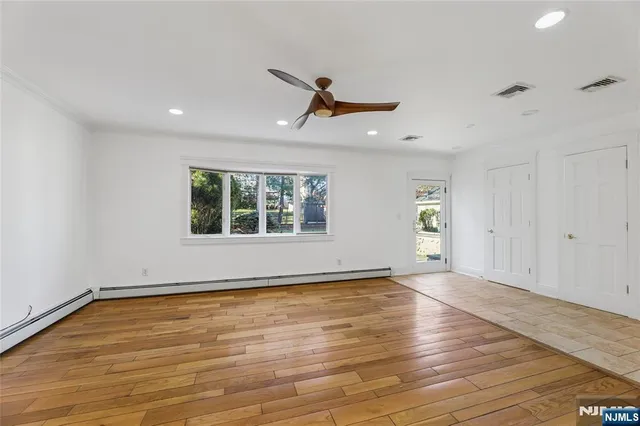 wooden floor in an empty room with a window