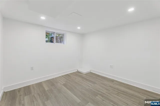 a view of a room with wooden floor and white walls