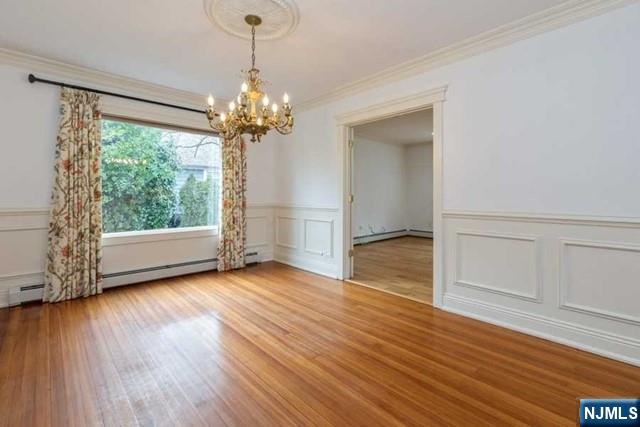 135 7th Street Cresskill, NJ 07626 - Photo 5 of 17 a view of an empty room with wooden floor and a window