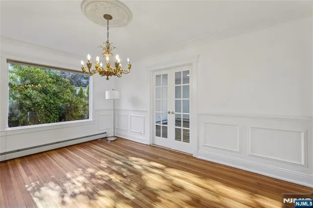 a view of a room with a large window wooden floor and glass door
