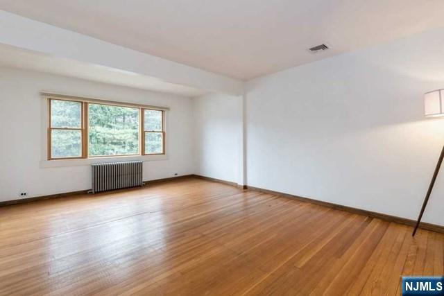 135 7th Street Cresskill, NJ 07626 - Photo 6 of 17 an empty room with wooden floor and windows