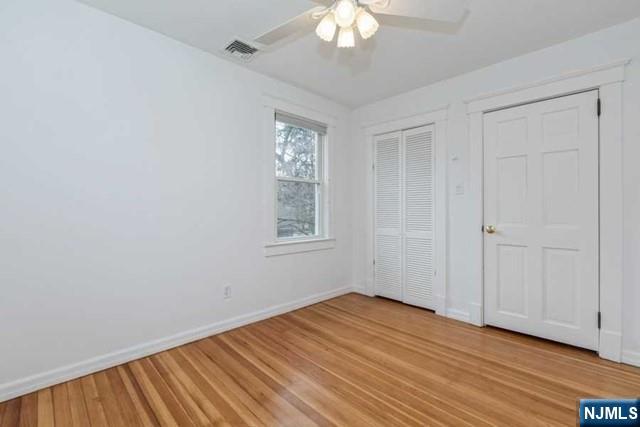 135 7th Street Cresskill, NJ 07626 - Photo 10 of 17 a view of an empty room with wooden floor and a window