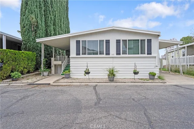 a front view of a house with a yard and a garage