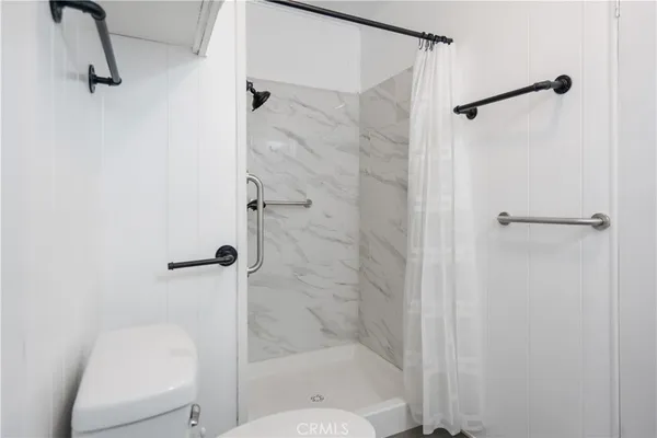 a bathroom with a shower and toilet