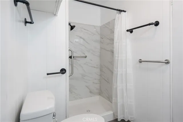 a bathroom with a shower and toilet