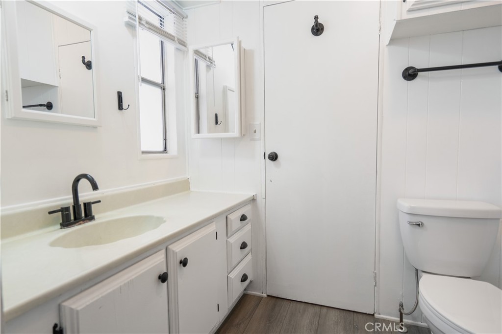 6480 Katherine, Unit 62 Simi Valley, CA 93063 - Photo 20 of 22 a bathroom with double vanity sink a toilet and a mirror