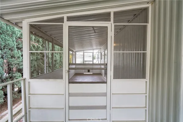 a white house with a big yard and plants