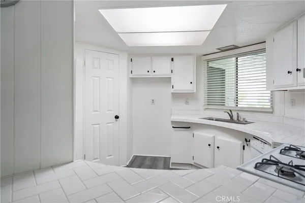 a kitchen with a sink and cabinets
