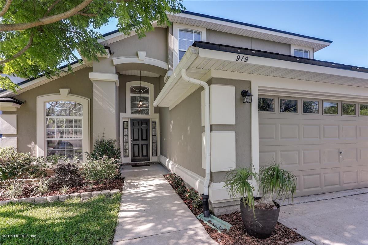 919 Silver Spring Court St. Augustine, FL 32092 - Photo 2 of 34 a front view of a house with a lots of flower plants