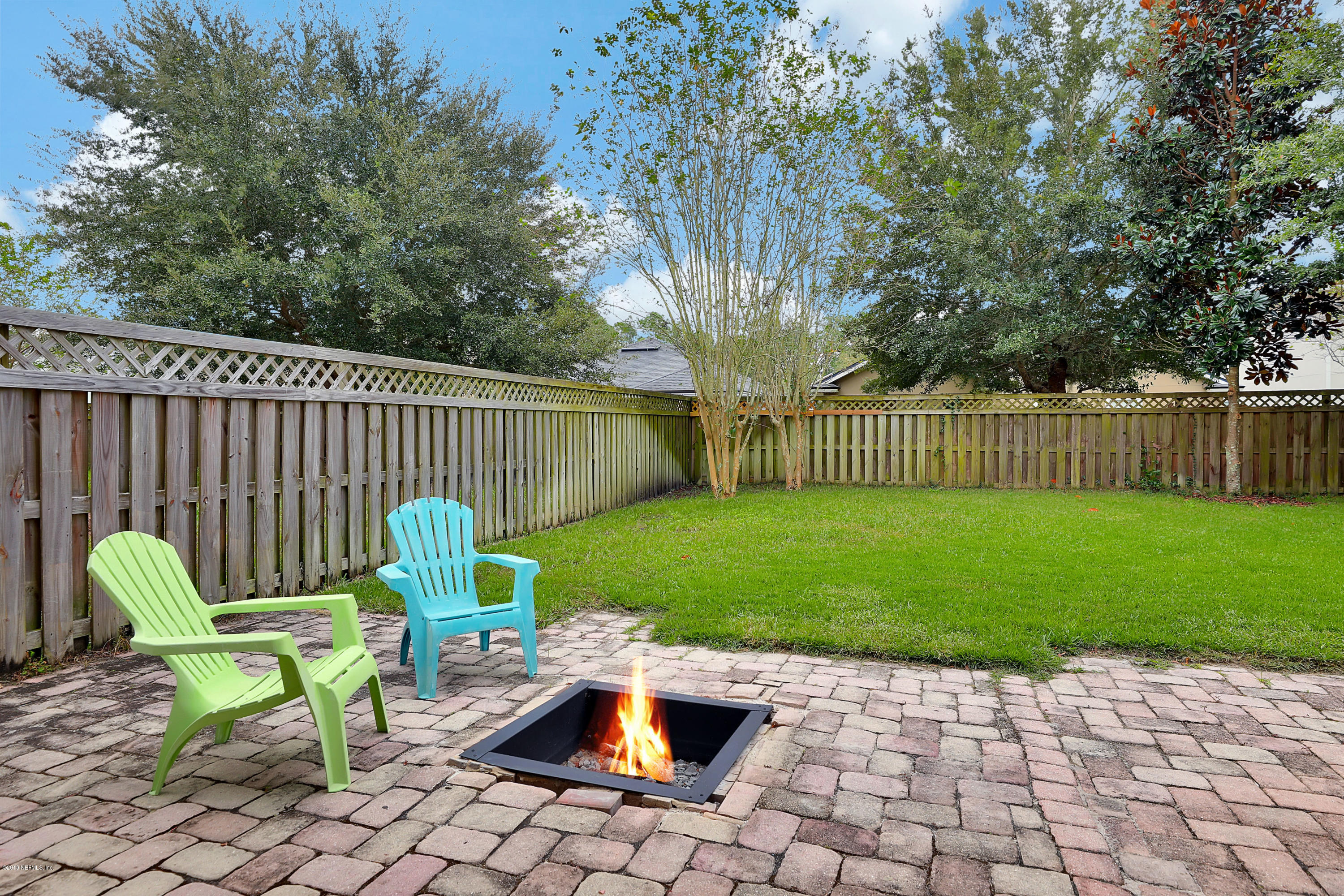 919 Silver Spring Court St. Augustine, FL 32092 - Photo 25 of 34 a view of a backyard with chairs potted plants and wooden fence