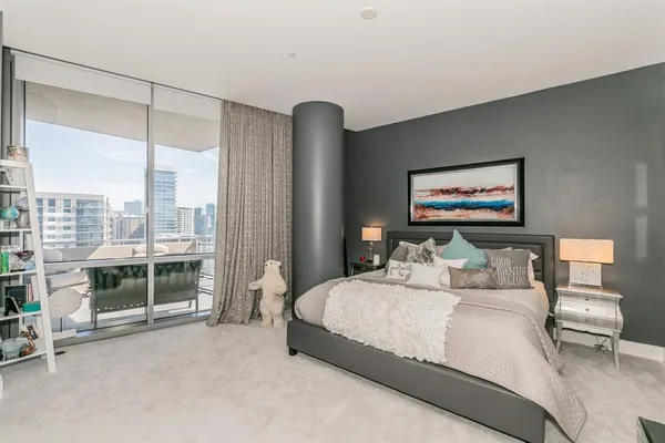 a bedroom with a bed couch and a window