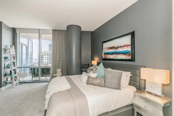 a bedroom with a large bed and a tv