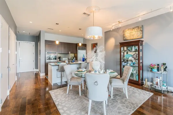 a kitchen with stainless steel appliances granite countertop a refrigerator and a stove top oven
