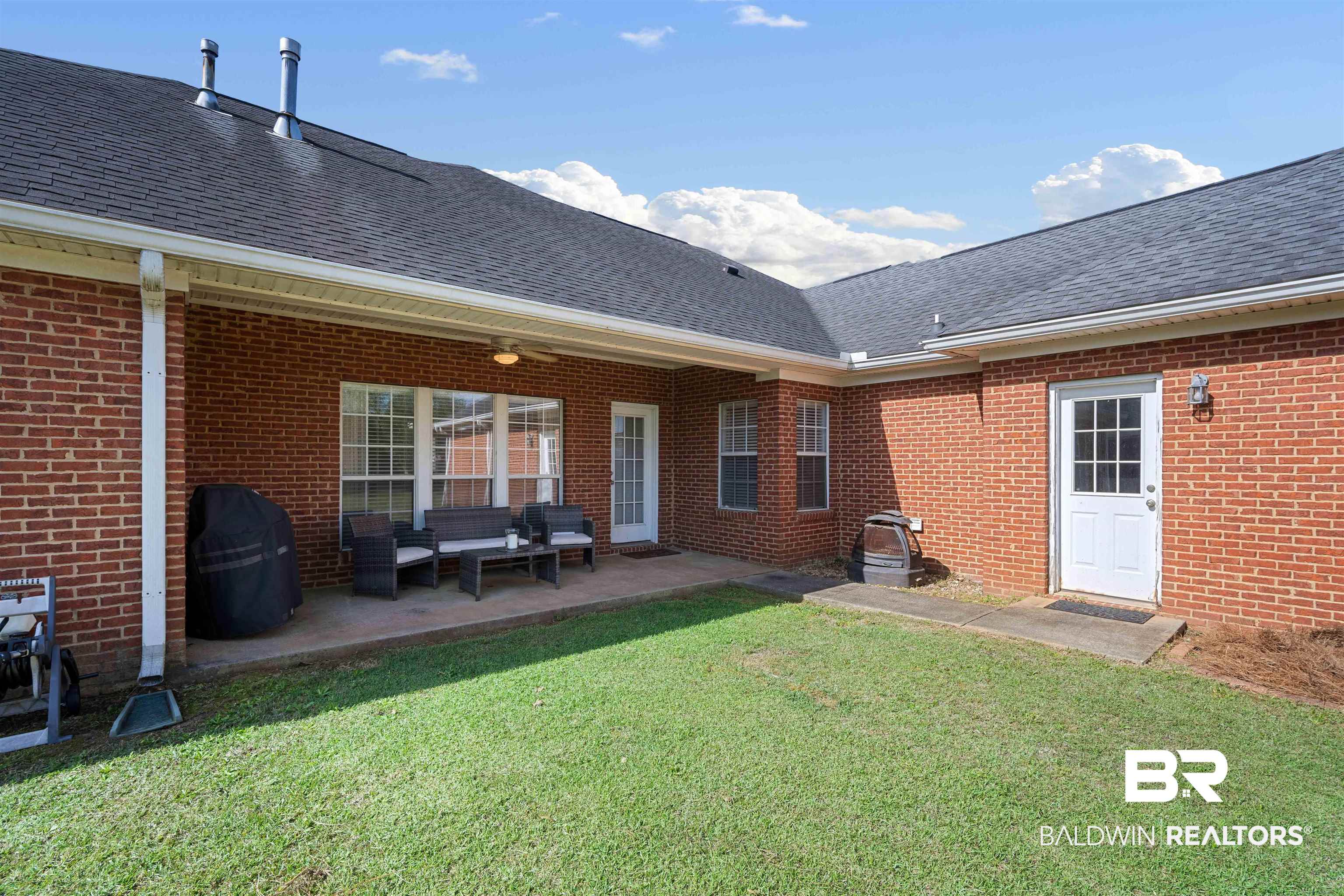 9552 White Castle Road Mobile, AL 36695 - Photo 29 of 31 Rear view of house outdoor lounge area, a lawn, and a patio