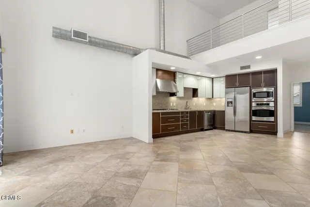 a view of kitchen with refrigerator and window