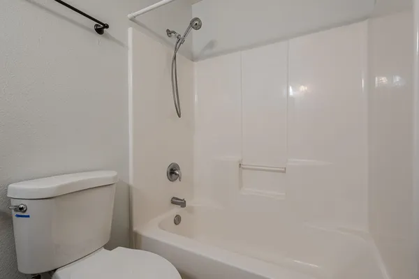 a bathroom with a toilet and a shower