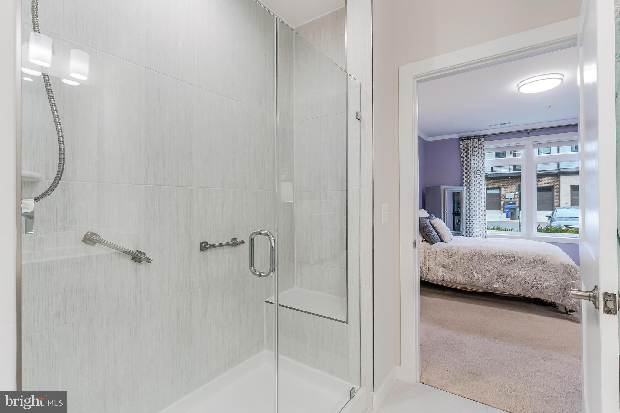 1675 Bandit Loop, Unit 105B Reston, VA 20190 - Photo 17 of 27 a en suite bathroom with a granite countertop tub shower and a sink