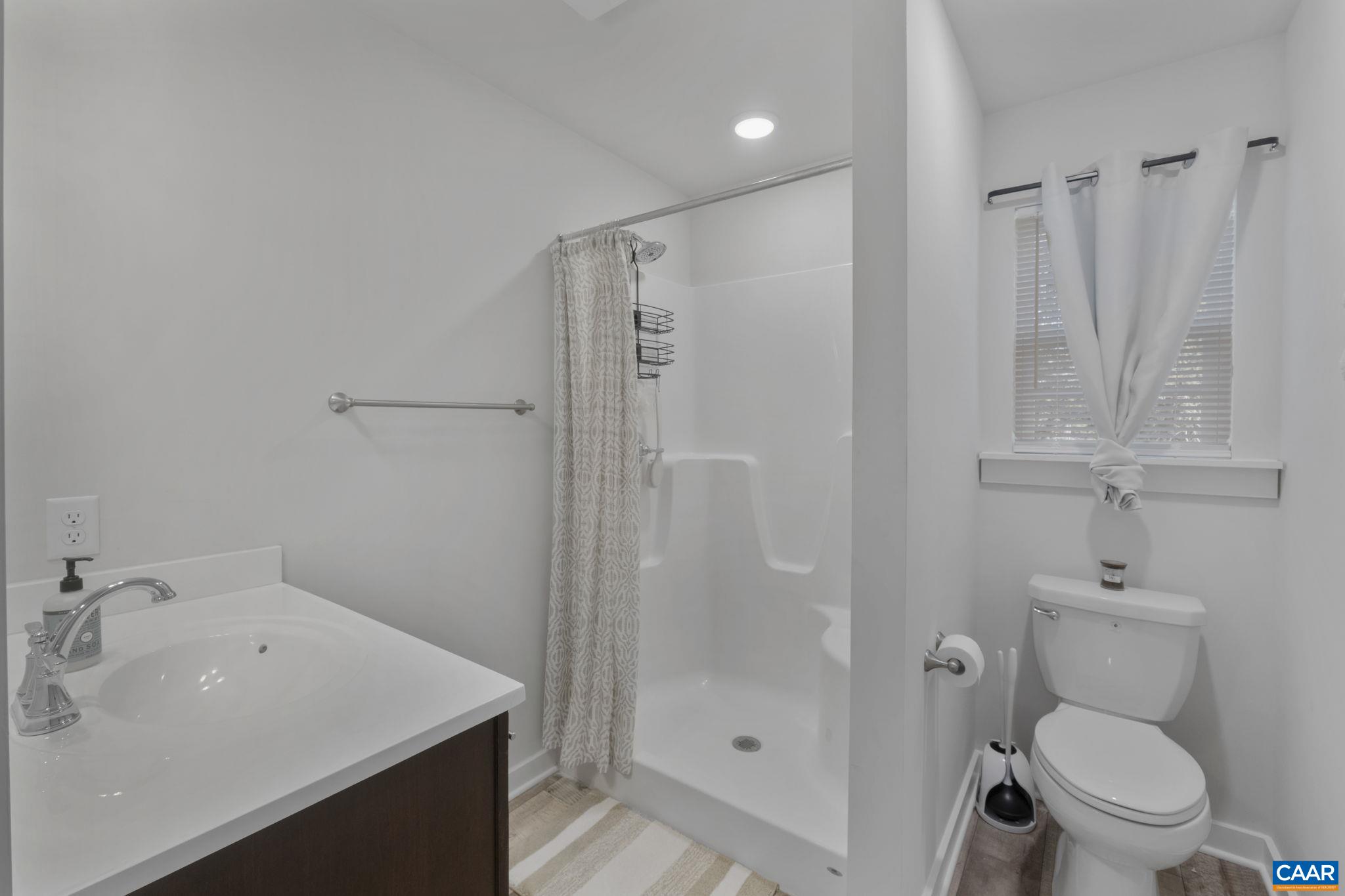7440 Louisa Road Gordonsville, VA 22942 - Photo 23 of 40 a bathroom with a sink toilet and shower