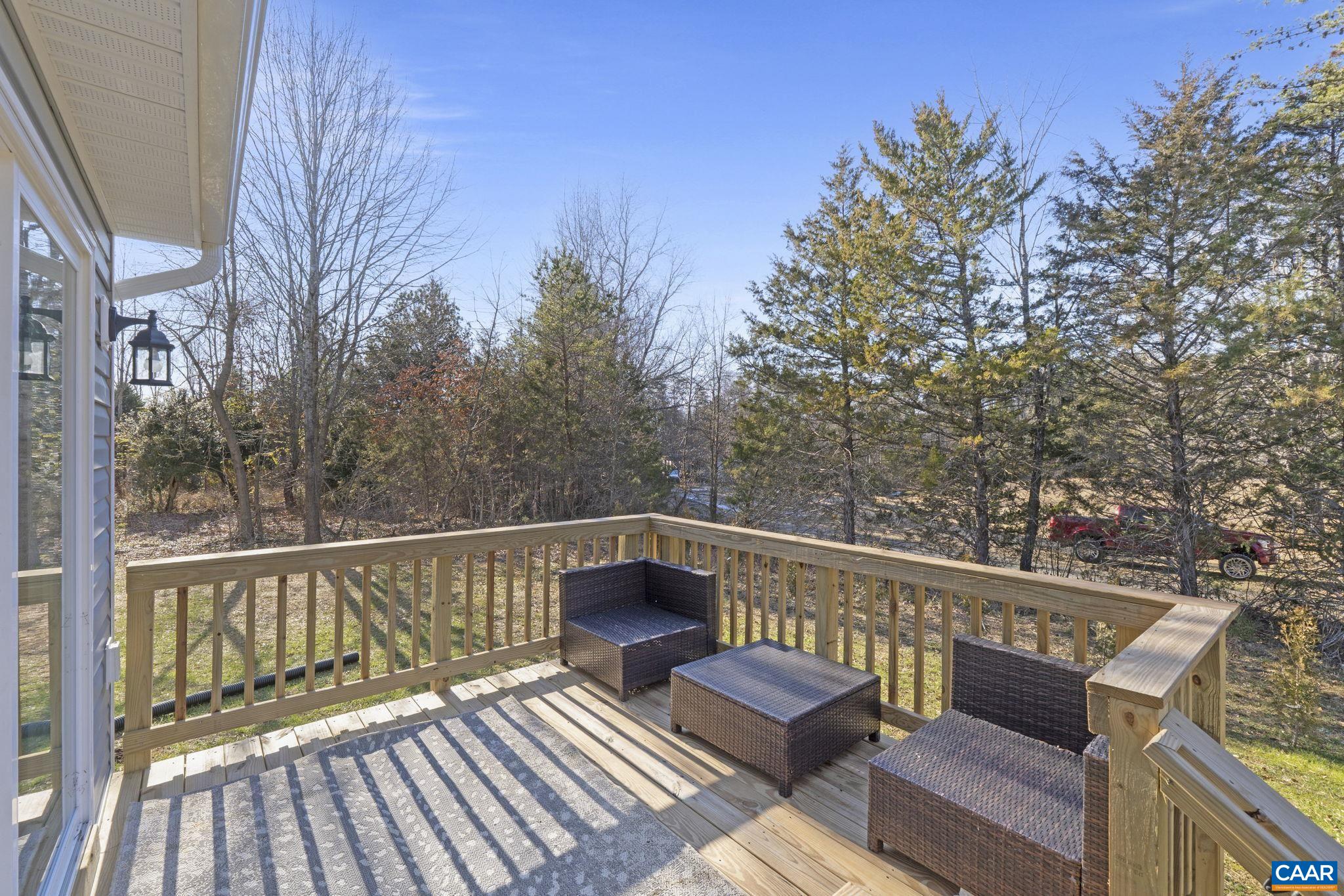 7440 Louisa Road Gordonsville, VA 22942 - Photo 37 of 40 a view of a balcony with wooden floor and outdoor seating
