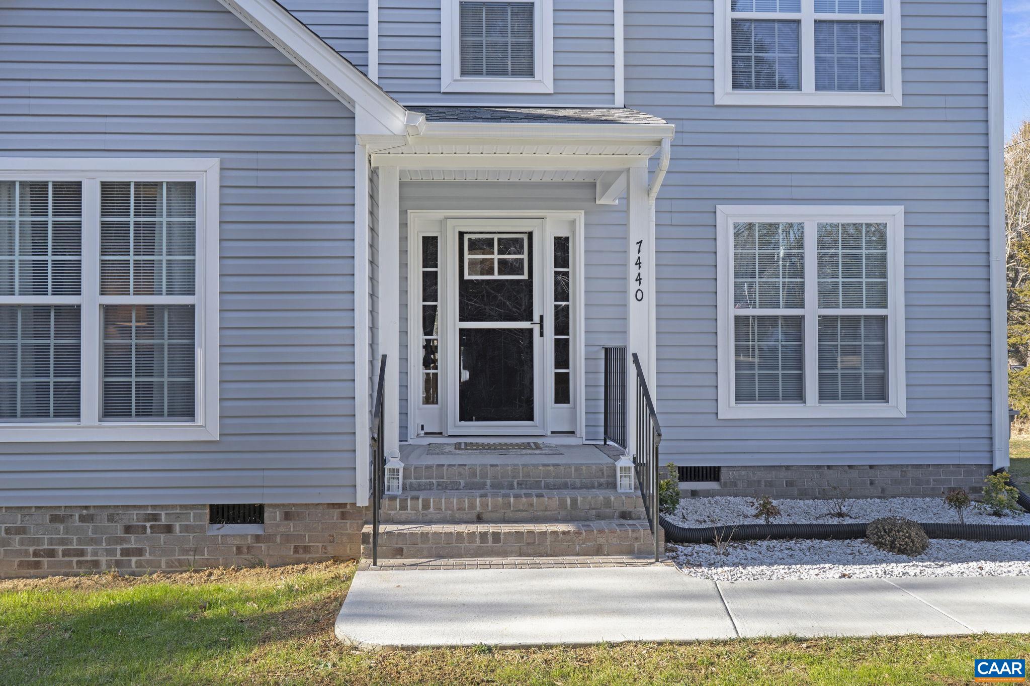 7440 Louisa Road Gordonsville, VA 22942 - Photo 4 of 40 a front view of a house with a yard